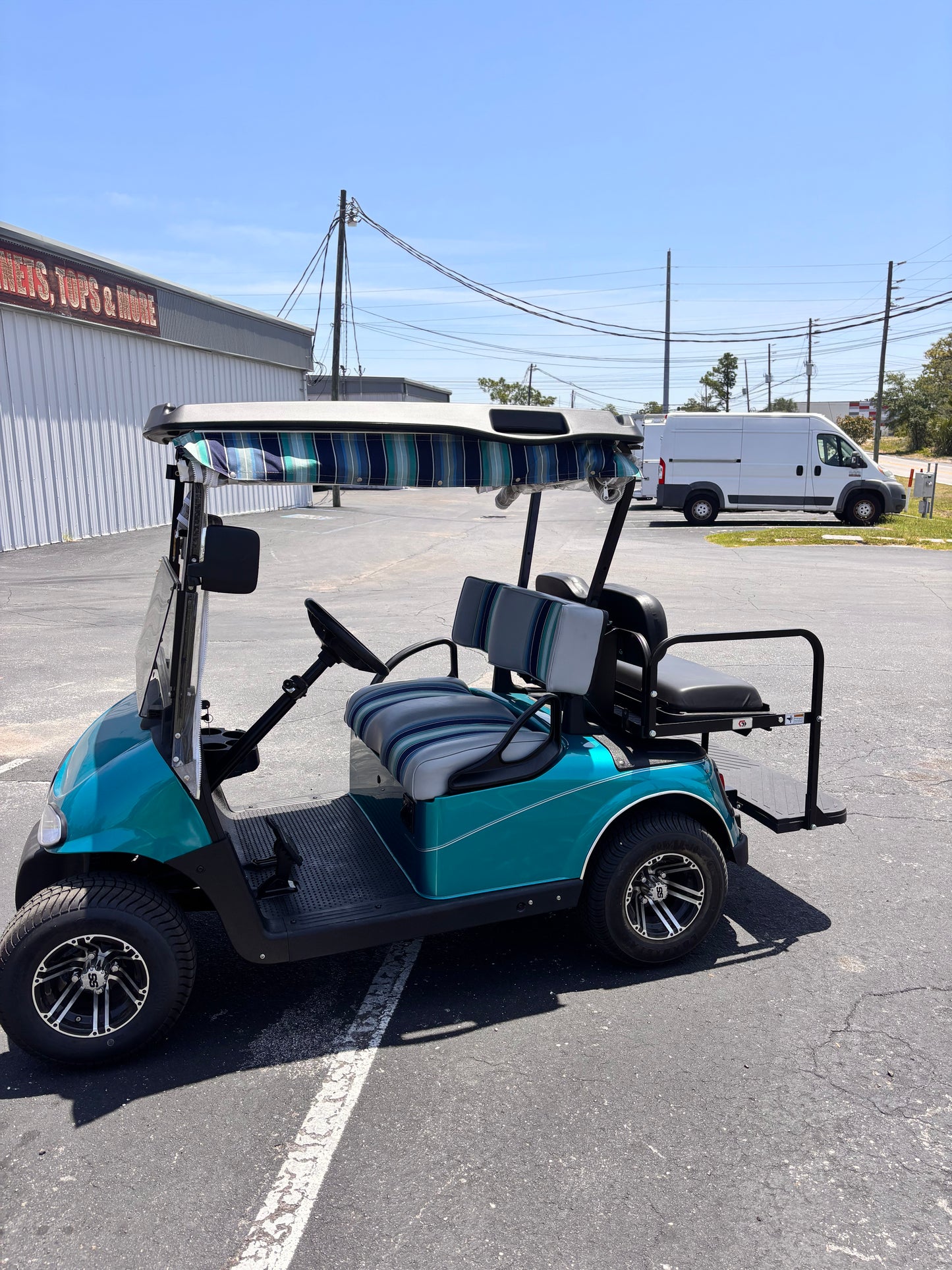 Turquoise 4 seater EZGO golf cart