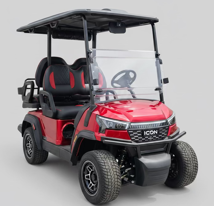 Red golf cart with 'For Sale' sign on a paved surface.