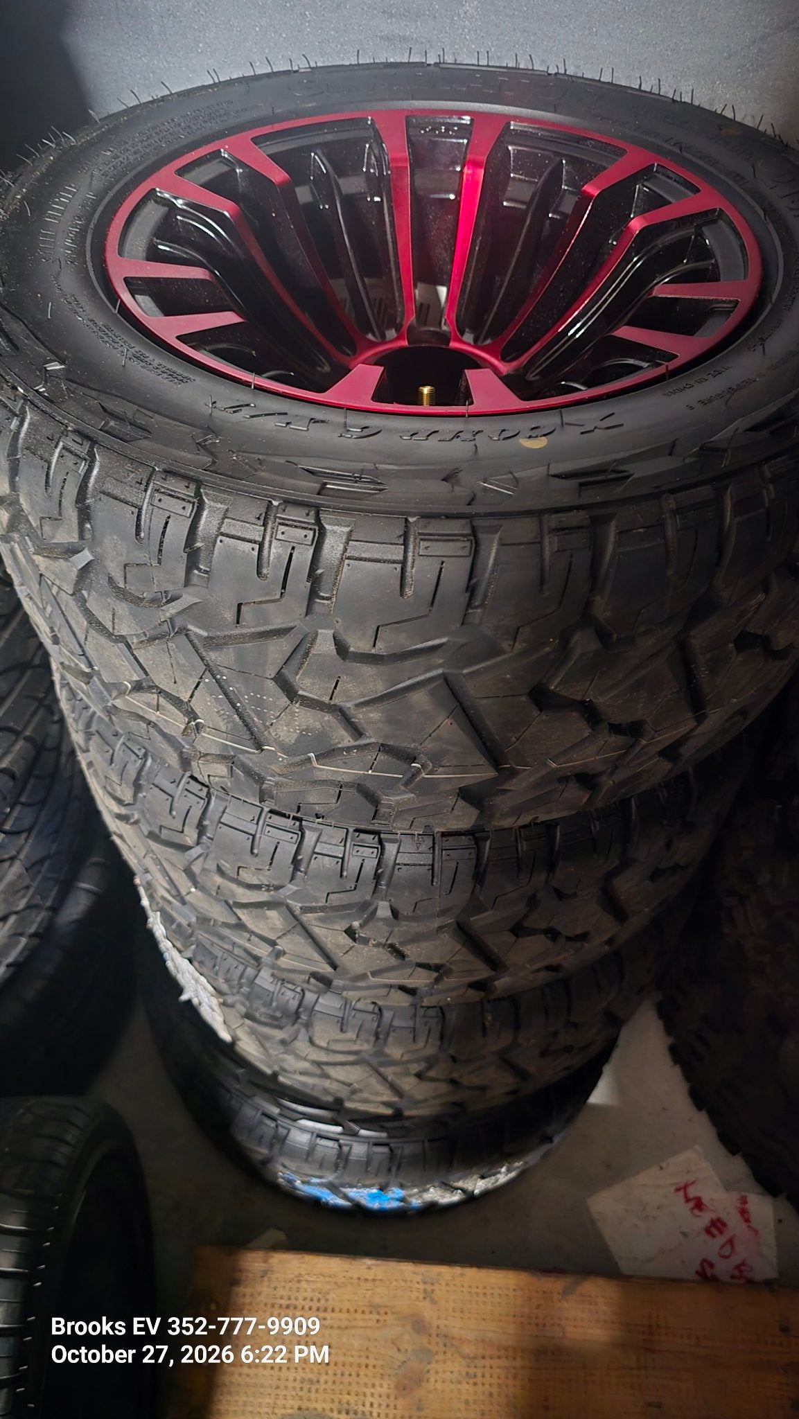 All-terrain golf cart tires on red and black wheels