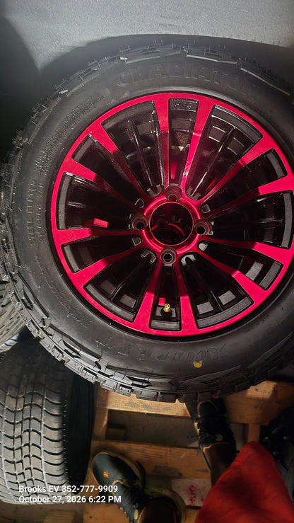 All-terrain golf cart tire on red and black wheel